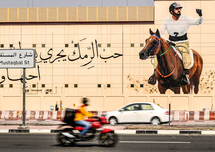 The sheikh's equestrian image looms in Dubai.